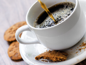 Coffee and oatmeal cookies on wooden table